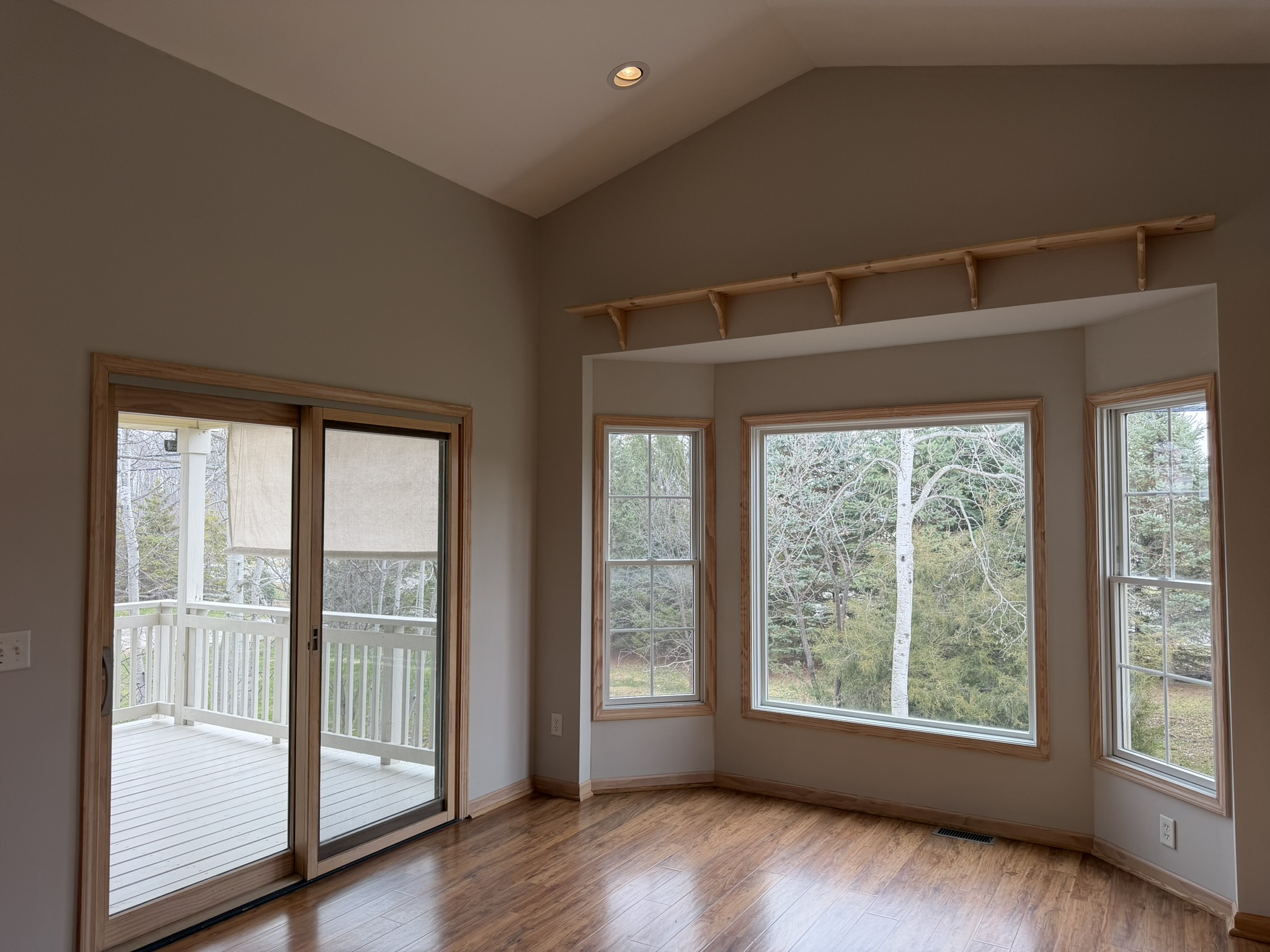 Breakfast nook with bay windows framing wooded views