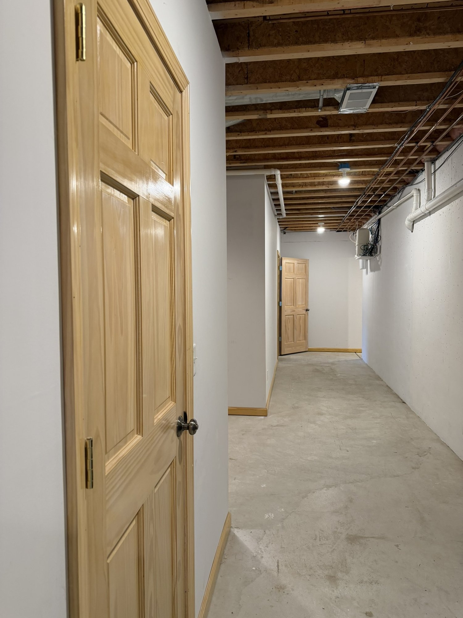 Bonus basement storage — long finished corridor with multiple storage rooms
